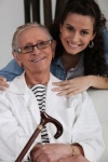 elderly woman sitting with cane and granddaughter
